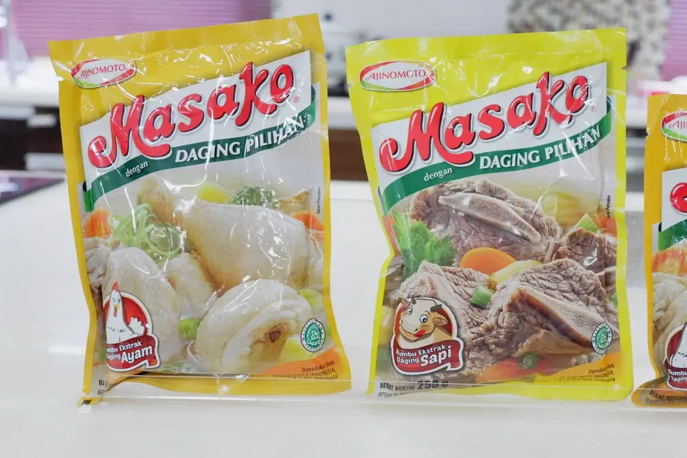 Two Masako yellow packaging each showing a chicken meat and beef seasoning powder flavours.