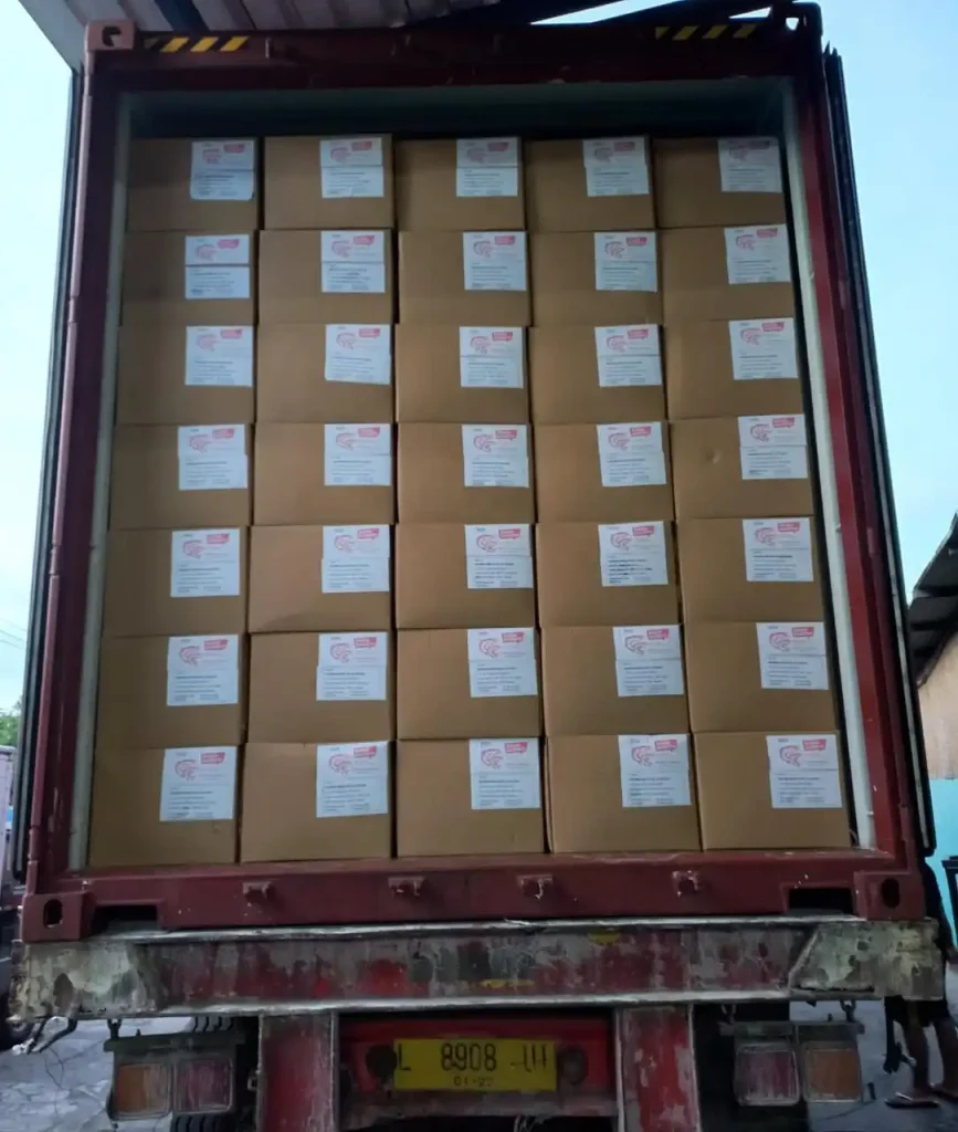 Container truck loaded with uniformly stacked product boxes for distribution by Inti Mandiri Jayatama.